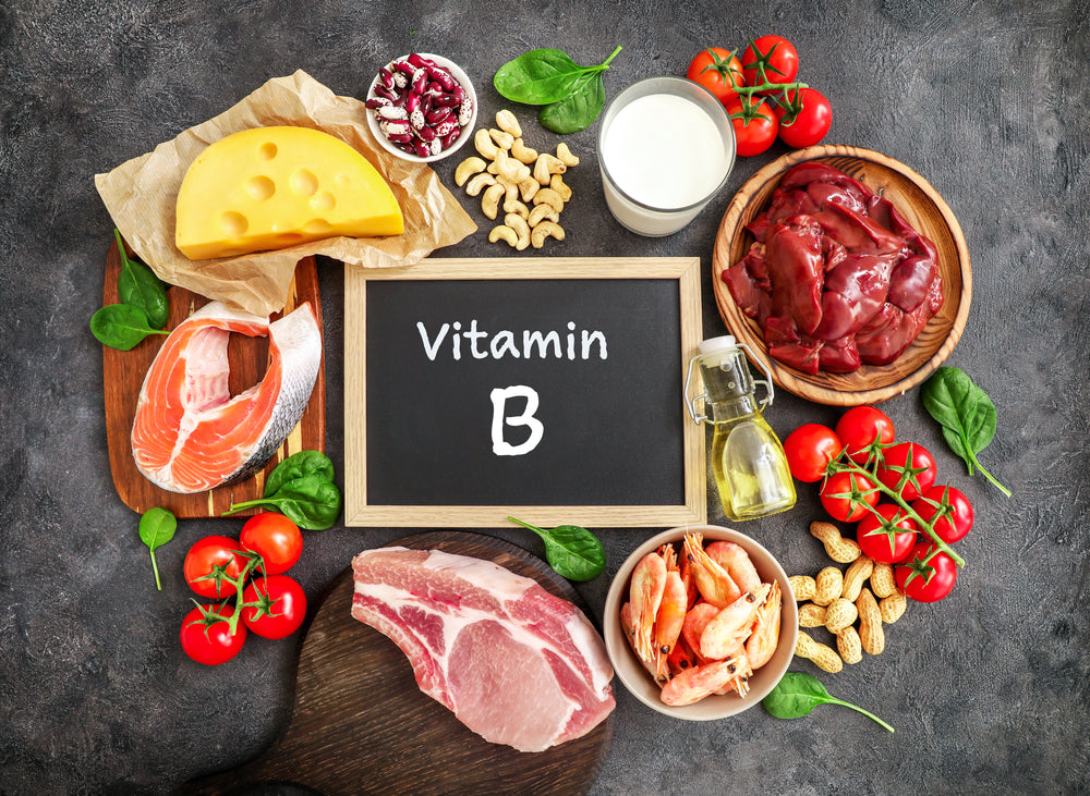 Sign that says b vitamins surrounded by b vitamin rich foods