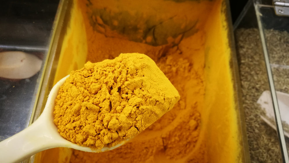 A scoop of tumeric powder.