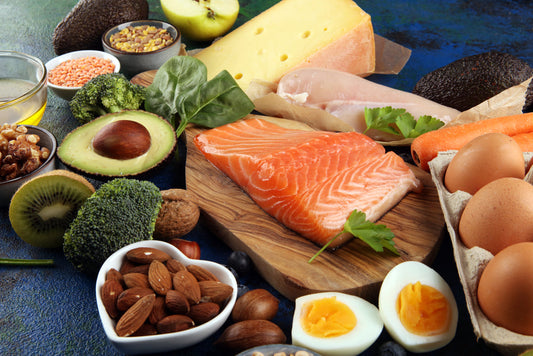 A table full of nutrient dense foods including salmon and other foods