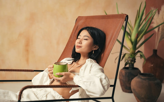 Closeup of japanese model enjoying herbal tea on her lounger, spending weekend at spa resort,