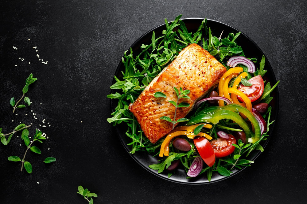 Salmon fillet grilled and fresh vegetable green salad of arugula 