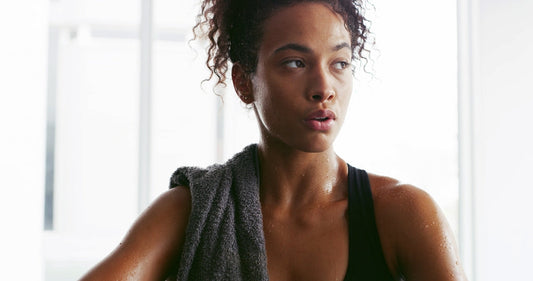 Sweat, towel and woman tired for fitness, intense training and workout at gym in morning. 