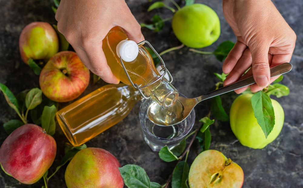 Apple cider vinegar against a background of apples. Selective focus. drink.