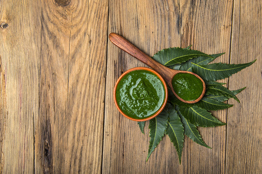 Medicinal Neem leaves with paste on wooden background