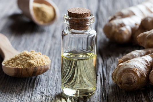 Ginger root, powder, and extract on a wooden table