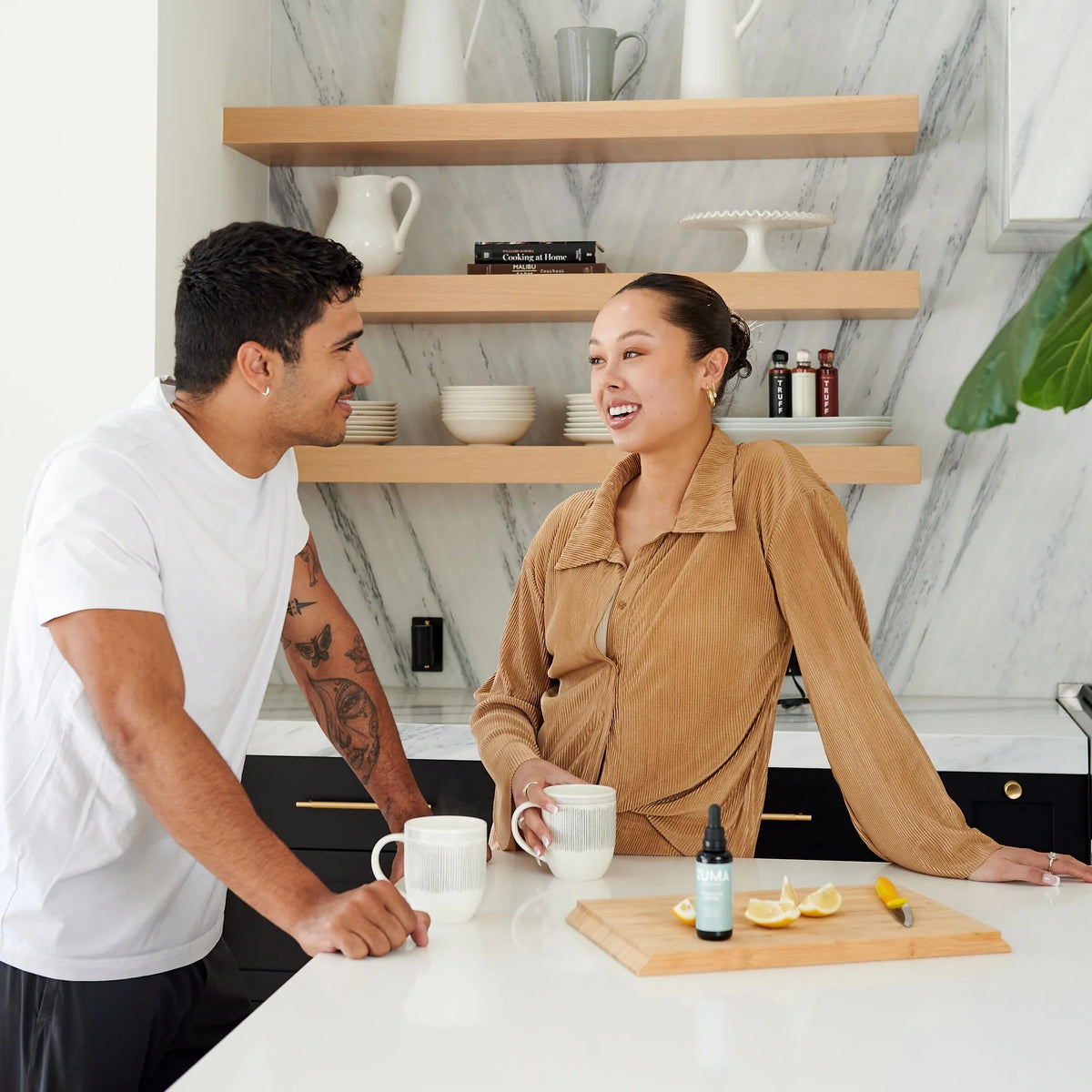 Two people sharing a morning routine with a Zuma Nutrition tonic