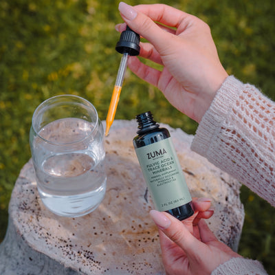 A dropper of Zuma Nutrition Fulvic Acid & Trace Ocean Minerals over a glass of water